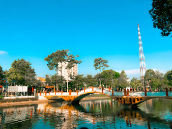 View of bridge over river against blue sky