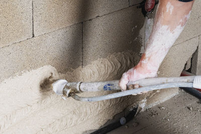 Man working on wet wall