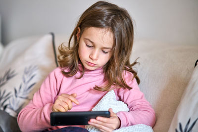 Girl using mobile phone at home