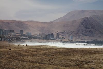 Scenic view of beach against cloudy sky