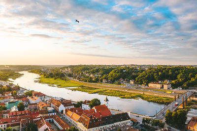 High angle view of river amidst buildings against sky