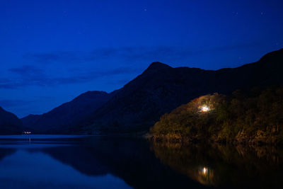 Scenic view of lake against sky at night