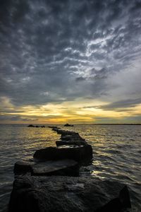 Scenic view of sea against cloudy sky