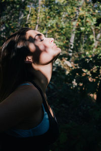 Midsection of woman with arms raised