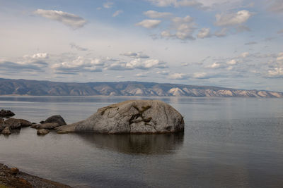 Rocks in sea against sky