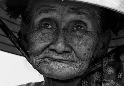 Close-up of senior woman wearing headwear