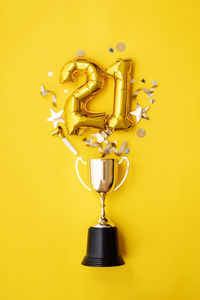 Directly above shot of christmas decorations on yellow background