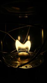 Close-up of illuminated light against black background