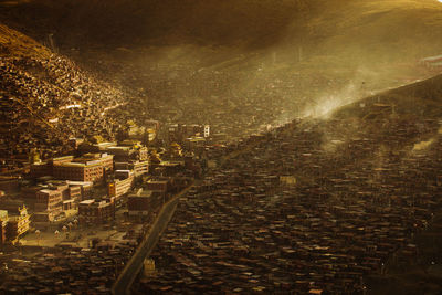 High angle view of illuminated cityscape against sky at night