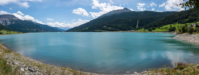 Scenic view of lake and mountains against sky