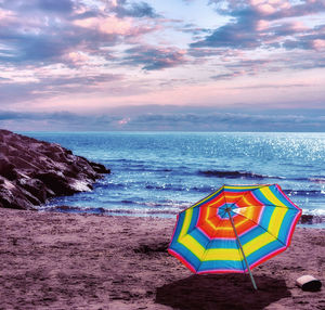 Scenic view of beach against sky during sunset