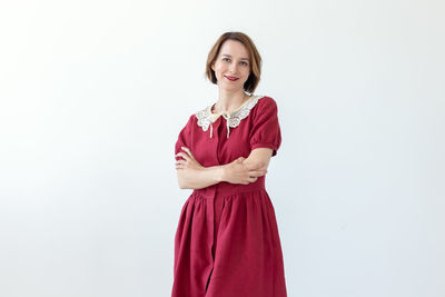 Portrait of a smiling young woman against white background