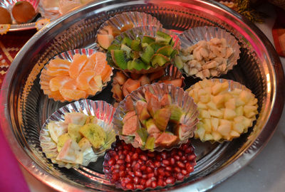 High angle view of various fruits in plates