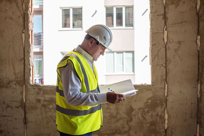 Side view of engineer working at construction site