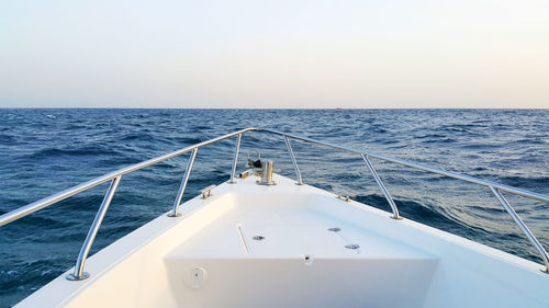 Boat sailing in sea against sky