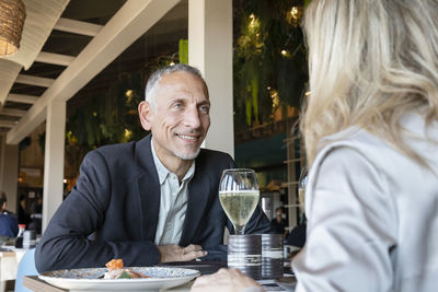 Romantic man looking at woman in restaurant