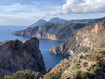 Panoramic view of sea and mountains against sky