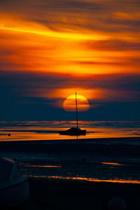 Scenic view of sea against orange sky