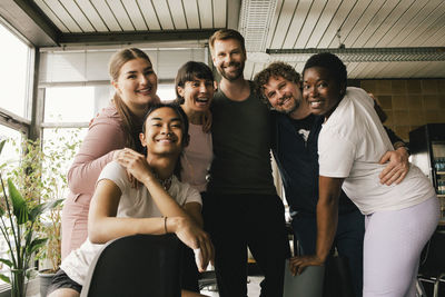 Portrait of happy multiracial colleagues enjoying at office