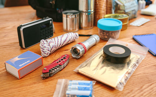 Emergency backpack equipment organized on the table in the living room