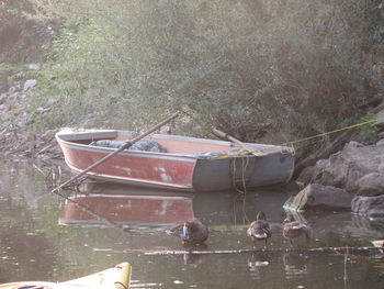 Abandoned boat floating on lake