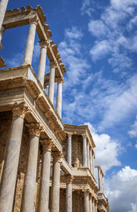 Low angle view of old building against cloudy sky