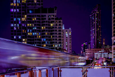 Low angle view of illuminated bridge at night