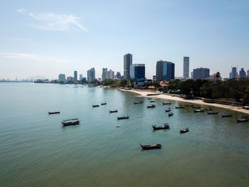 Scenic view of sea and buildings against sky