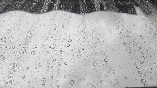 Full frame shot of raindrops on window