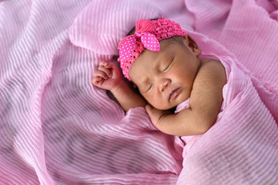 Close-up of baby boy sleeping in bed