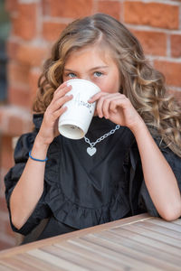 Portrait of girl drinking coffee