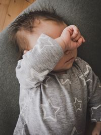 Close-up of cute baby boy sleeping on bed at home