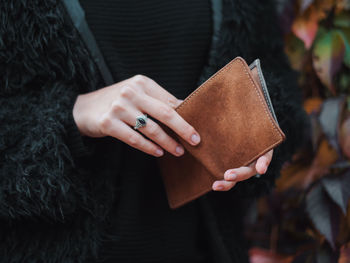 Close-up of midsection of woman holding purse