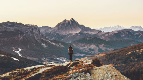 Rear view of person standing on cliff at dolomites