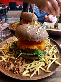 Close-up of person eating food on table in restaurant