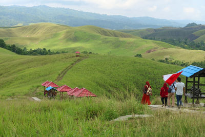 People on field against mountain