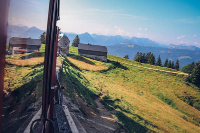 View from the moving historic train on the schafberg mountain to the surrounding countryside alps