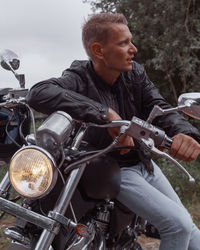 Full length of young man riding motorcycle