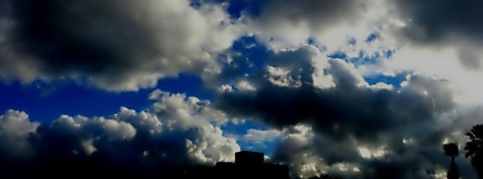 Low angle view of building against cloudy sky