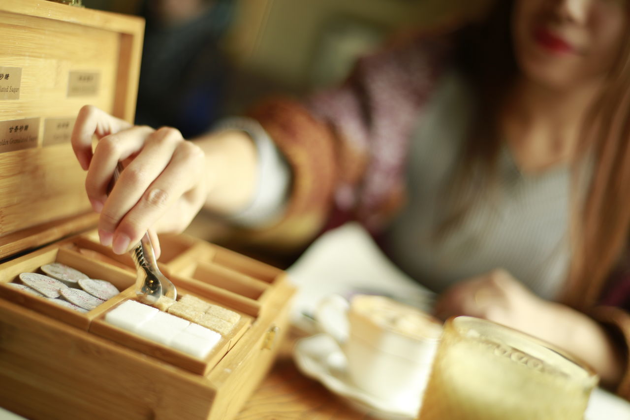 indoors, person, holding, lifestyles, part of, focus on foreground, communication, cropped, close-up, selective focus, book, table, text, human finger, men, leisure activity, education