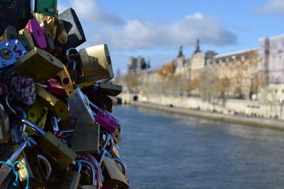 Close-up of padlocks on bridge over river