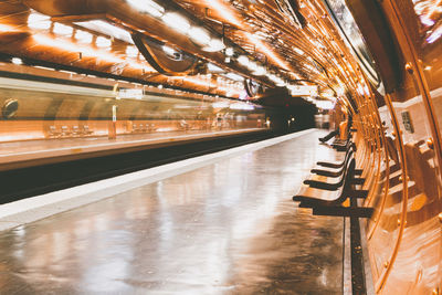 Illuminated railroad station platform at night