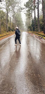 Rear view of man on wet road