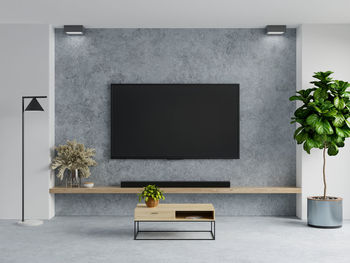 Concrete wall mounted tv in living room interior on concrete background.3d rendering