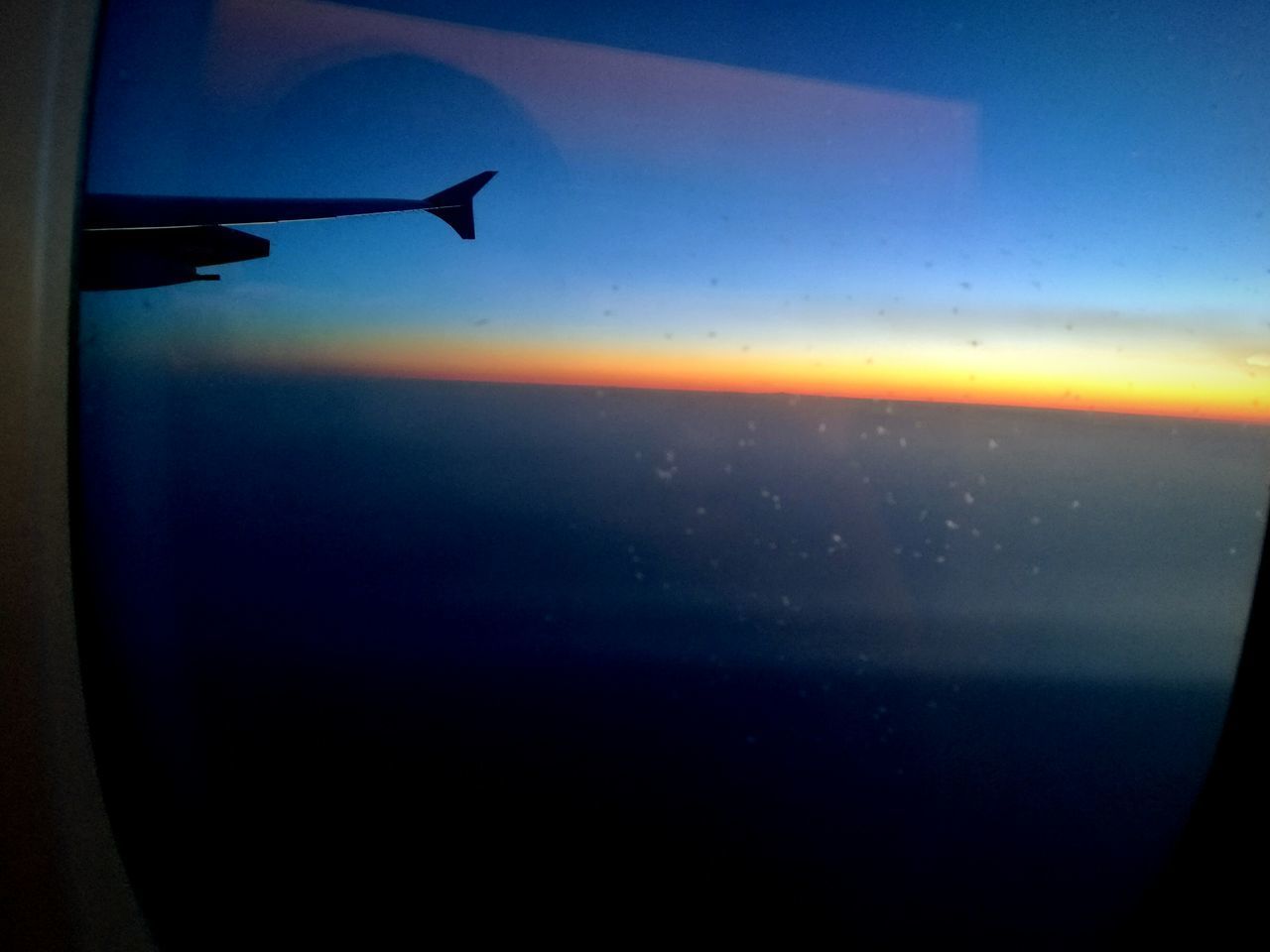 CLOSE-UP OF AIRPLANE WING OVER SEA