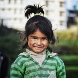 Portrait of smiling girl standing outdoors