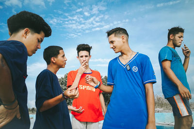 Group of people against blue sky