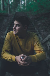 Portrait of young man sitting outdoors