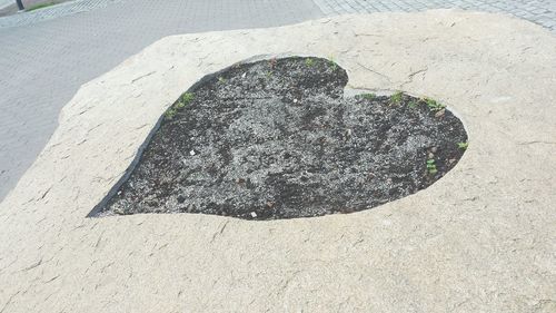 High angle view of heart shape on rock