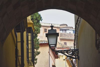 Low angle view of electric lamp mounted on wall